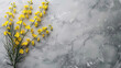 A bouquet of yellow flowers is placed on a marble countertop. The flowers are arranged in a way that they are almost hidden by the countertop, creating a sense of depth and contrast