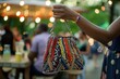 hand clutching a beaded handbag at an outdoor summer festivity