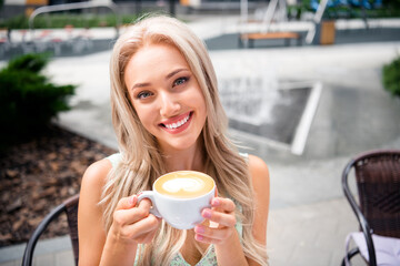 Canvas Print - Photo of cute pretty shiny young girl holding cup tasty coffee latte enjoying free time moment vacation weekend springtime outside