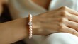 hand woman with a silver, gold , pearl bracelets