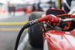close up of refueling hose attached to racing car