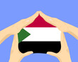 Hand home with Sudan flag, residential or investment idea, housing and home concept
