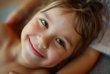 Fototapeta Sawanna - child with a smile getting a gentle touch massage