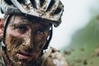 closeup of cyclists muddy face showing determination