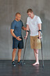© peopleimages.com - Physical therapy, crutches and patient with disability to exercise at clinic for recovery, strength and healthcare rehabilitation. Physiotherapist, support and consultation or workout for amputee
