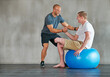 © peopleimages.com - Physical therapy, amputee and exercise ball with a man with a disability and physio for rehabilitation. Physiotherapy, help and healthcare professional with trainer helping and wellness for mobility