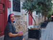 female summer old town walk in Antalya Turkey. Woman with colorful hair and dress strolls through enchanting old town of Antalya , vibrant fusion of fashion and history