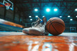 Basketball Shoes and Ball on Wooden Basketball Parquet at the Basketball Arena. Basketball Player’s Equipment. Sports Arena With Basketball Basket in Blurred Background