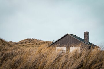 Scenic view of a house on the Bjerregard beach on a cloudy day in Hvide Sande, Denmark