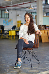 Poster - Business, woman and portrait with confidence in office for creative internship, relax and startup pride in chair. Entrepreneur, employee and serious in a warehouse workspace and coworking workplace