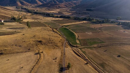 Wall Mural - Is an aerial view of a rural farm, featuring lush green fields