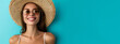 Banner. Image of a gorgeous positive woman smiling happily on a blue background. Cute girl in sunglasses and a big beach hat. Travel and vacation concept. Long-awaited vacation. Space for text