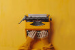 Inspired writer typing on a vintage typewriter, isolated on a creative mustard yellow background, channeling literary creativity