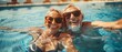 Senior Couple Smiling Underwater in Swimming Pool