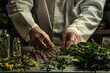 A person wearing a white coat meticulously arranges flowers
