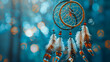 A dream catcher hanging from a tree in the snow ,A dream catcher hanging from a rope in the snow,Dreamcatcher against a white blur of snow
