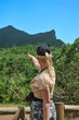 A young woman with white hair in the middle of the forest is going to the mountains on background