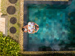 © AmazingAerialAgency - Aerial view of Oberoi Beach with luxury resort and person enjoying floating breakfast, Balaclava, Mauritius.
