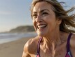 © Jordi E. - primer plano de la cara de una mujer de avanzada edad sonriente corriendo por la playa con un bañador colorido.Ai