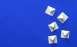 White notification message mail envelopes on blue background. Creative minimalism layout