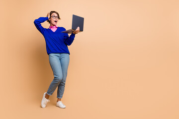 Sticker - Full body portrait of impressed pretty lady hand touch head use laptop empty space isolated on beige color background