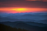 Fototapeta Góry - Sunset Spectrum: Layered Mountain Silhouettes Against a Hazy Backdrop of Red, Purple, Blue, Yellow, and Orange