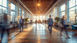Motion blur of people walking rapidly in corporate building hallway