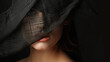 Portraint of a model in a black veil  in mourning. Mysterious and enigmatic woman. Secretive. Closeup studio image.