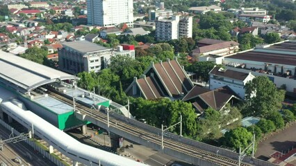 Canvas Print - Jakarta City Train Station and Train. Cityscape in Background. Indonesia