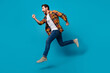 © deagreez - Full length photo of nice young guy hands running fast hurry shopping dressed stylish checkered garment isolated on blue color background