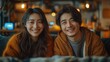 an asiatic young couple looking to camera with a smile