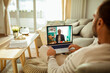 © Davor - Man having video call with financial advisor from home