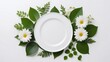 Empty plate with leaves on white table, decor, flowers