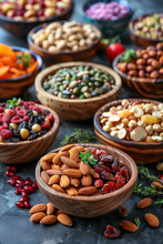 Various Types Of Nuts And Fruits In Bowls On A Dark Background