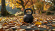Kettlebell on ground surrounded by autumn leaves.