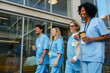 © BONNINSTUDIO/Stocksy - Smiling healthcare workers with takeaway coffee taking a break