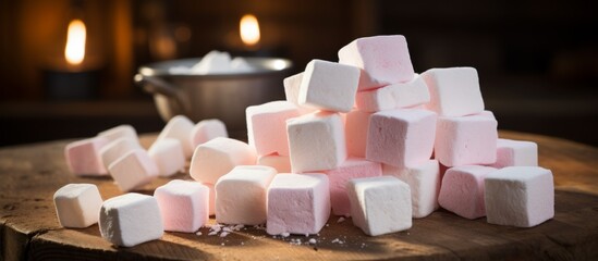 Poster - A rectangular wooden table displayed a pile of magenta and white marshmallows. The transparency of the plastic container highlighted the sweetness of this dessert ingredient