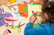 © Gemma can fly/Stocksy - Messy craft kid. Little girl doing art crafts