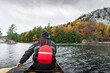 © JP Danko/Stocksy - Paddling Canoe on Wilderness Lake with Autumn Forest