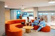 © BONNINSTUDIO/Stocksy - Healthcare workers taking a break sitting on sofa