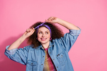 Wall Mural - Photo of funky dreamy lady dressed denim outfit adjusting hairband looking emtpy space isolated pink color background