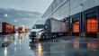 © john - The truck is parked on the loading dock of an industrial warehouse, where many trucks with semi-trailers load goods