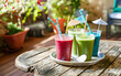 Sweet smoothie in plastic cups on wooden table
