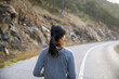 © Jovo Jovanovic/Stocksy - Rear view of athlete jogging on mountain road