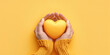 Top view of hands holding yellow heart in hands. Yellow Dat conceptual banner
