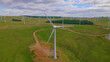 AERIAL: Wind power station with many wind turbines generating electric energy