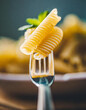 close up pasta with sauce dipped on the tip of a fork