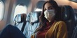 Woman wearing a mask on the airplane while traveling on vacation to help prevent the spread of diseases to immunocompromised people
