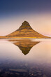 Amazing sunset view of the Kirkjufell. Symmetric reflection over the lake,  Iceland
