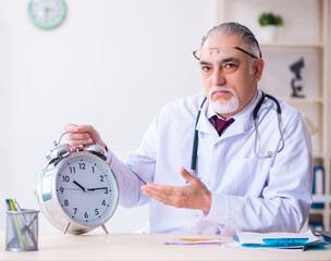 Sticker - Old male doctor working in the clinic